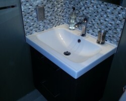 Hanging vanity, tile floor and baseboards.