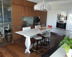 Two styles of kitchen cabinets up to the ceiling.