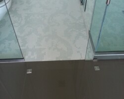 Smooth transition between mosaic and porcelain floors.