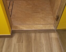 Flat shower floor with linear drain.