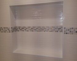 Custom made tiled niche with mosaic.