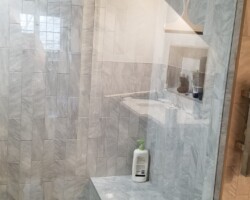 Unusual shower room with bench and custom niche.