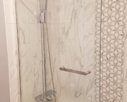 Ceramic tiles and mosaic around new tub.
