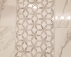 Accent stripe of mosaic on the tile wall.
