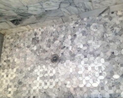 Marble mosaic shower floor.