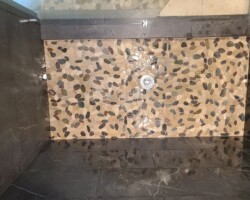 Huge shower room with pebbles mosaic.