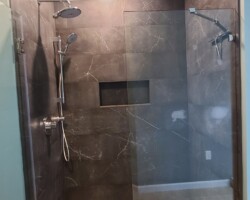 Updated shower room with porcelain tiles and mosaic.