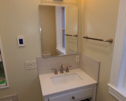 Tile backsplash and baseboards add durability.