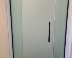 Standard corner shower door installed on custom shower room.
