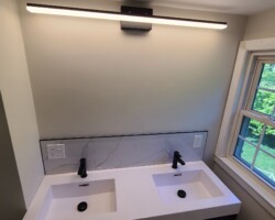 Double sink vanity with big vanity lights.