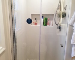 Bi-fold glass shower door.