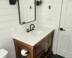 Rustic looking vanity and heated floor.