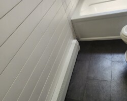Shiplap on the walls outside the tub.