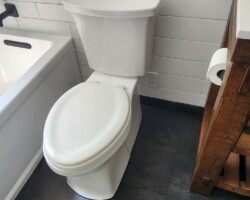 Power outlet next to toilet for future washlet installation.