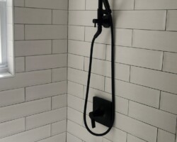 Black shower trim om white tile looks classic.