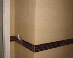 Outside corner made from metered cuts of ceramic and glass tiles.