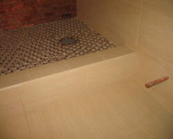 Square shower drain on square glass mosaic looks perfectly good.