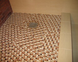 Glass mosaic shower floor.