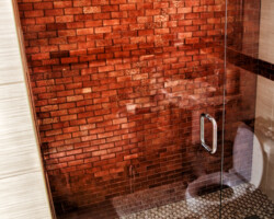 New shower with glass tile on accent front wall.