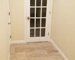 Tiled floor and glass door to entertainment room.