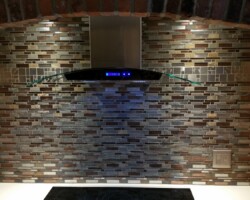 Kitchen backsplash. Tile replacement, new light and range hood.