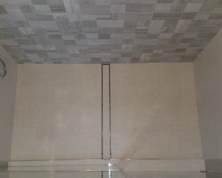 Flat shower floor with linear drain.