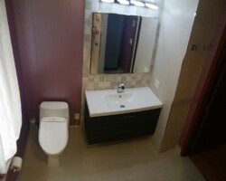 Tiled corner for vanity instead of simple backsplash.