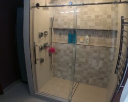 Sliding glass shower door.