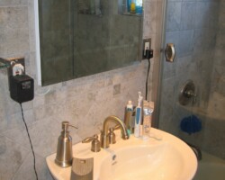 Pedestal sink and recessed medicine cabinet.