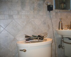 Another view of toilet tank shelf.