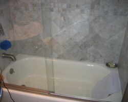 Sliding glass doors on top of the tub.