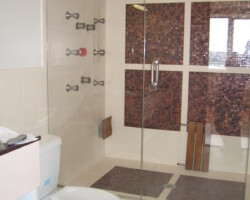 Steam room combined with shower. Glass mosaic on the walls.