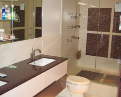 Double sink vanity hanging on a wall. Steam shower on a back.