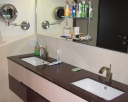 Double sink vanity hanging on a wall.