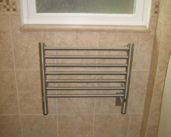 Towel warmer installed on a wall.