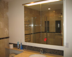 Mirror medicine cabinet makes room bigger.