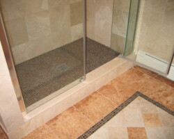 Step to shower made of the same marble.