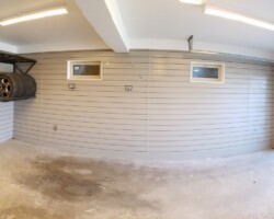 Walls covered with plastic panels and storage accessories.
