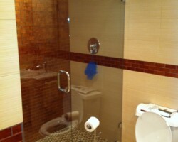Glass and ceramic tiles combination on the walls and glass mosaic on the shower floor.