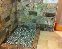 Corner step to shower made of marble tiles.