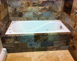 Jacuzzi surrounded with Black Forest marble tiles.