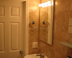 Marble tiles installed up to the ceiling.