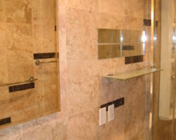 Mirror medicine cabinet and shelf above the toilet.
