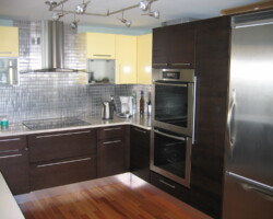 Metal mosaic backsplash and stainless steel appliances.